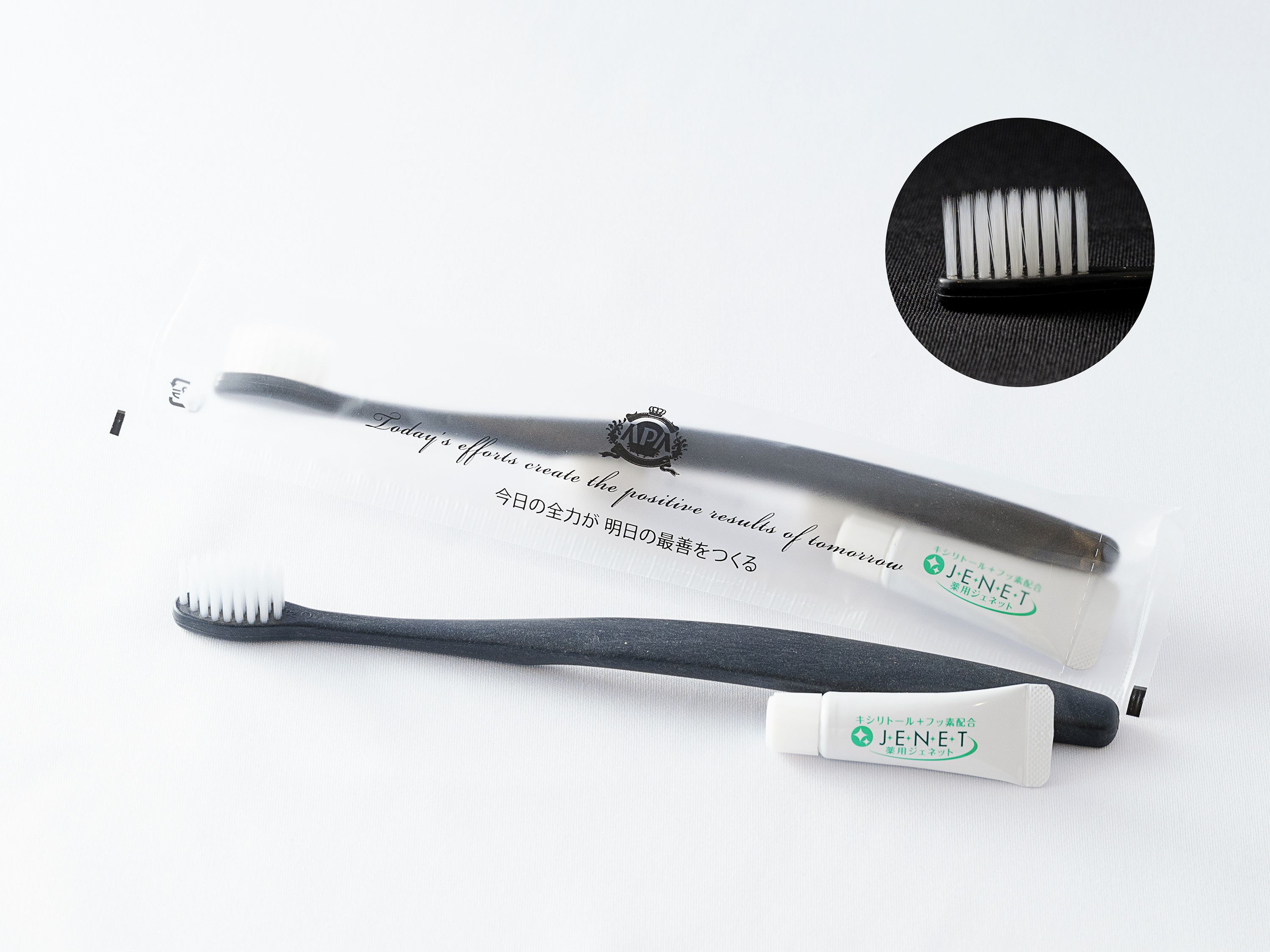 A toothbrush and a tube of toothpaste with text in multiple languages.
