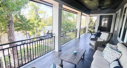River front paradise with large dock and outdoor space, great for entertaining.
