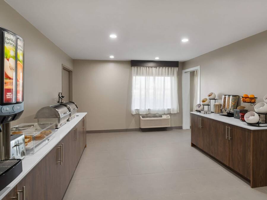 A modern kitchen with a coffee station, a toaster, and a refrigerator.