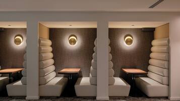 A modern, minimalist lounge area with tiered seating and built-in lighting.