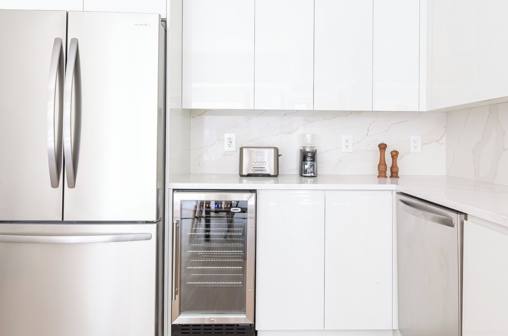 A modern kitchen with a built-in oven, a coffee maker, and a toaster.