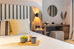 A modern hotel room with a bed, bedside table, and a desk with a chair. - Casa Blue Hotel (Skiathos)