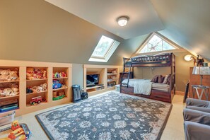 A child's bedroom with a bunk bed, shelves with toys, a large rug, and a skylight. - Hot Tub, Gym, Game Room! Luxe Estate in Longmeadow (Longmeadow)