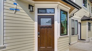 A front door with a window above it, a mailbox, and a small step leading to the door. - Walk to Beach & Shops: Dtwn Anacortes Apartment! (Anacortes)