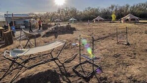 A campsite with tents, a barbecue grill, and a clear sky. - Bisti Badlands Tent (Farmington)