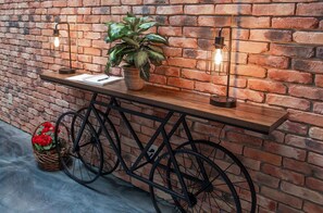 A wooden bench with a potted plant and a notebook against a brick wall. - Trails to Ales Trails Suite 4 (Franklin)