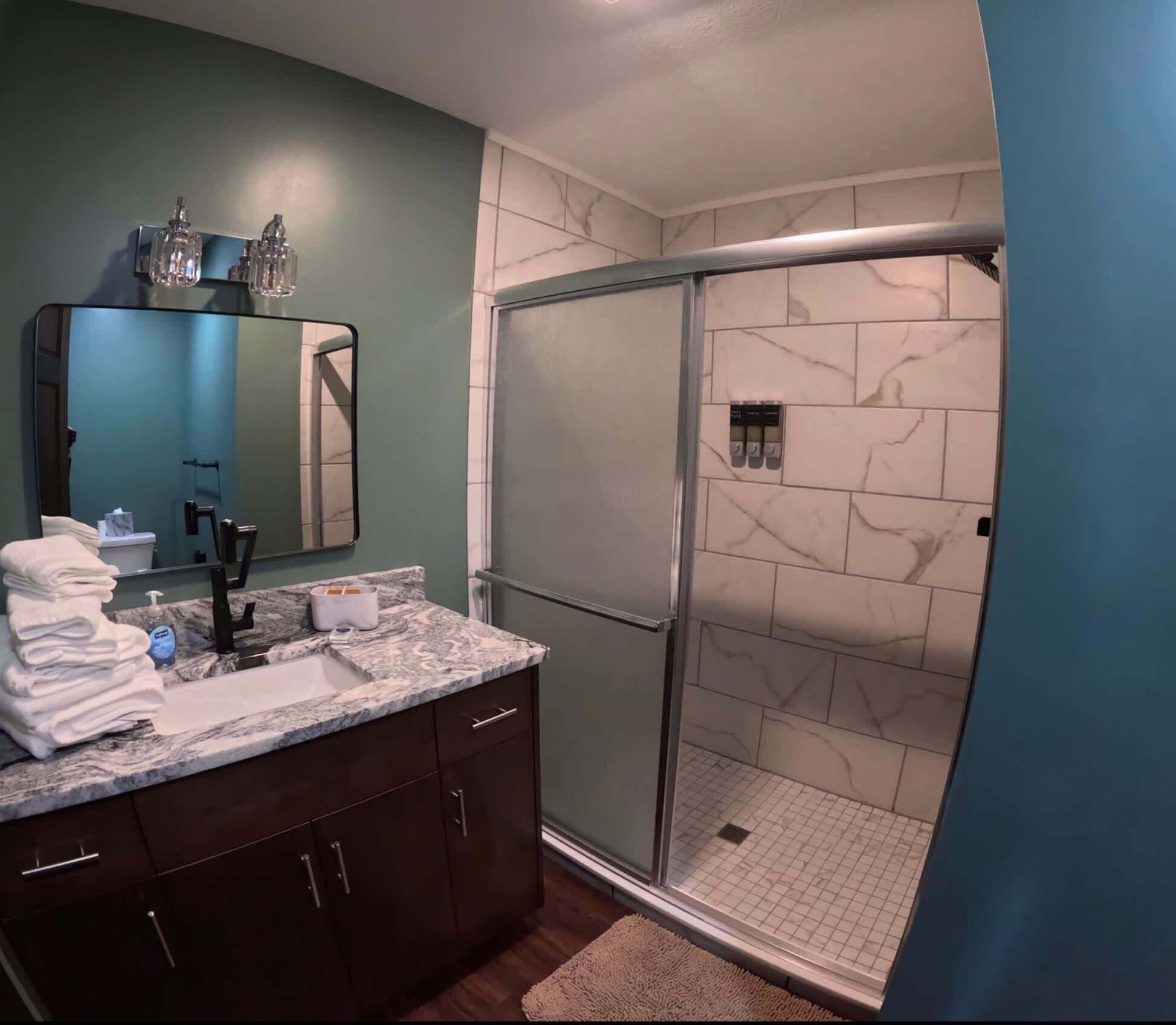Shower, hair dryer, towels, shampoo