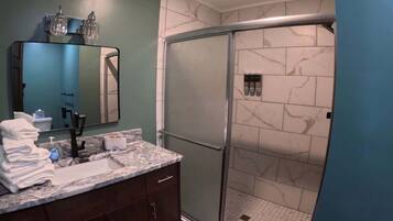 Shower, hair dryer, towels, shampoo