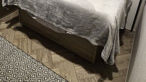 A bedroom with a bed, a TV, and a wardrobe. - Nature Lover's 2-Bedroom RV Escape (Hamilton)