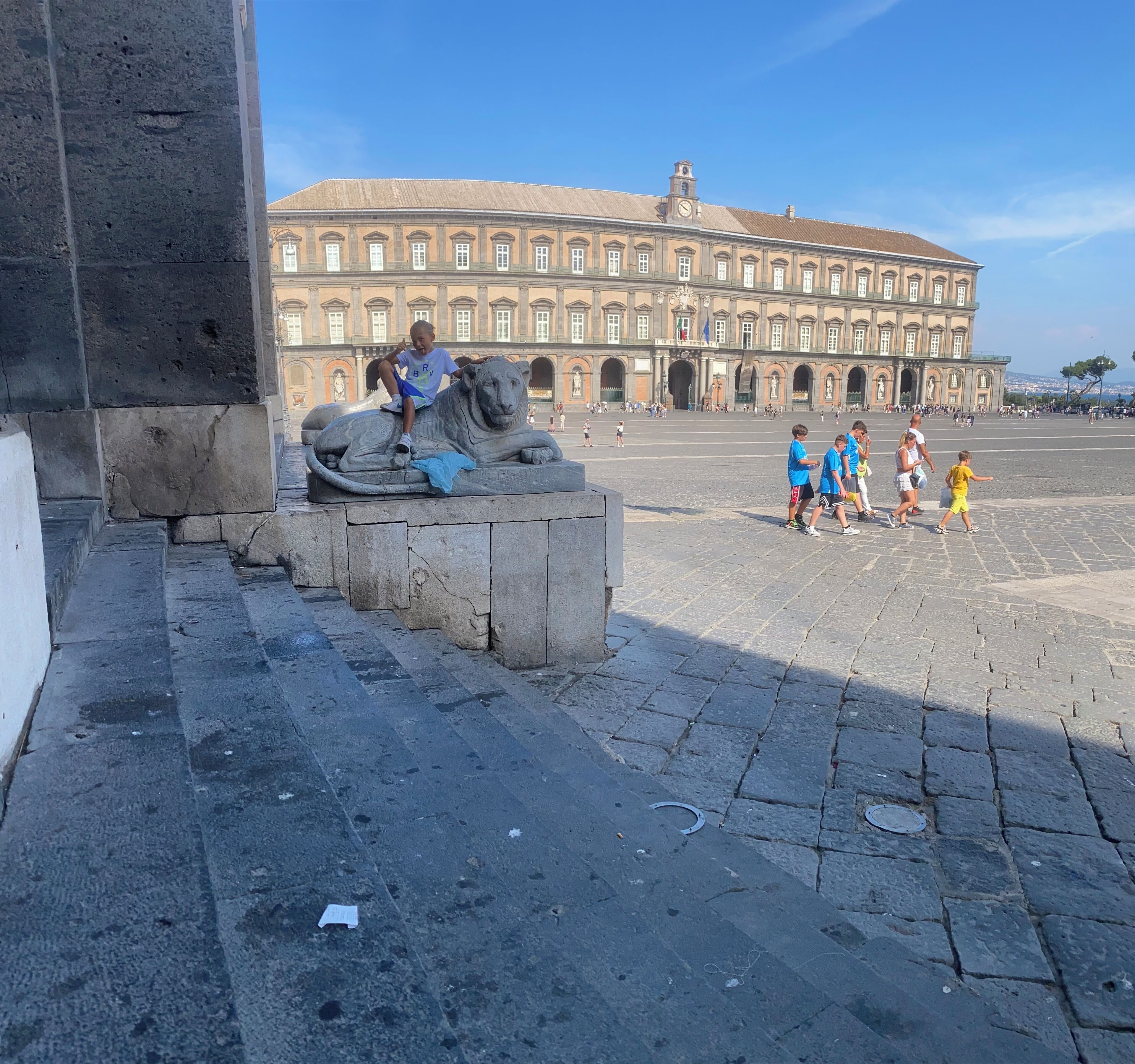 A large public square with a historical building in the background.