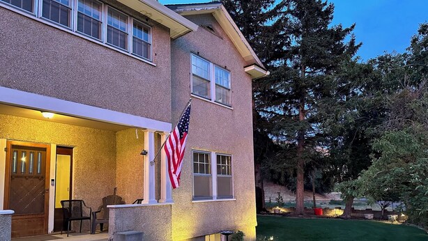A two-story house with a front porch, a flag, and a well-maintained lawn. - The Vinson House
Historic 5 bedroom 2 bath ranch house (Pilot Rock)