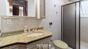 A bathroom with a granite countertop sink, a mirror, a toilet, and a shower enclosure. - 2 Bedroom apt 350m fr the Beach, BC Center Btr0302 (Balneário Camboriú)
