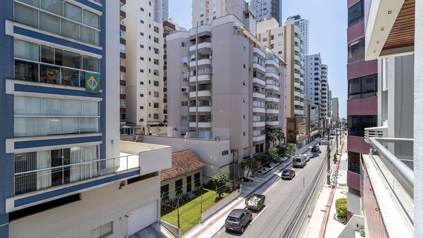 A multi-story residential building with balconies, a street view, and a clear sky. - 2 Bedroom apt 350m fr the Beach, BC Center Btr0302 (Balneário Camboriú)
