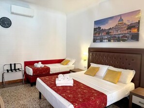 A hotel room with two beds, a red sofa, a clock, and a painting of a cityscape. - Grand Gaeta  (Rome)