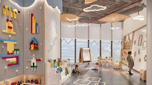 A modern children's playroom with LEGO walls, a large window view, and a chalkboard.
