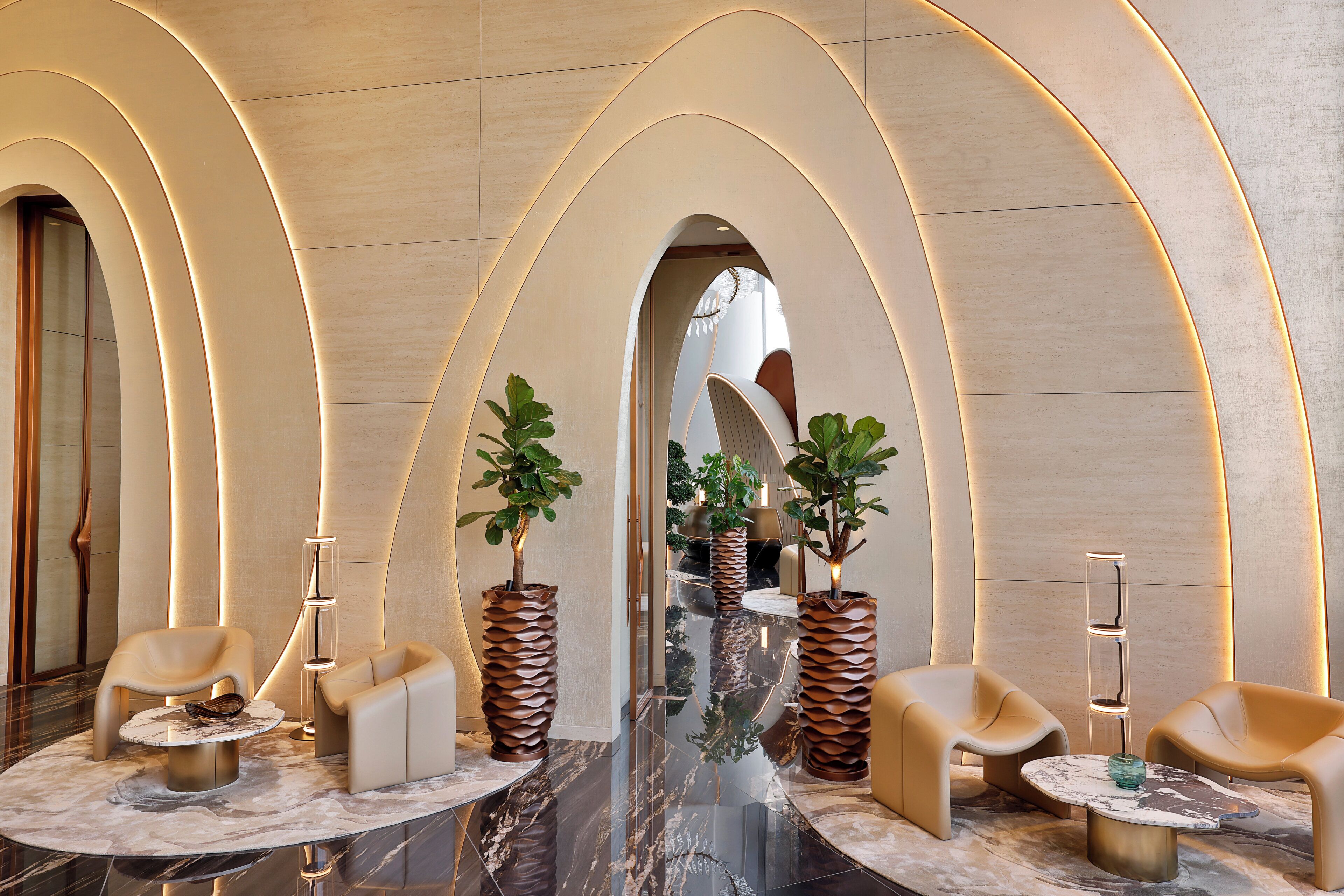 A modern lobby with arched ceilings, marble flooring, and contemporary furniture.