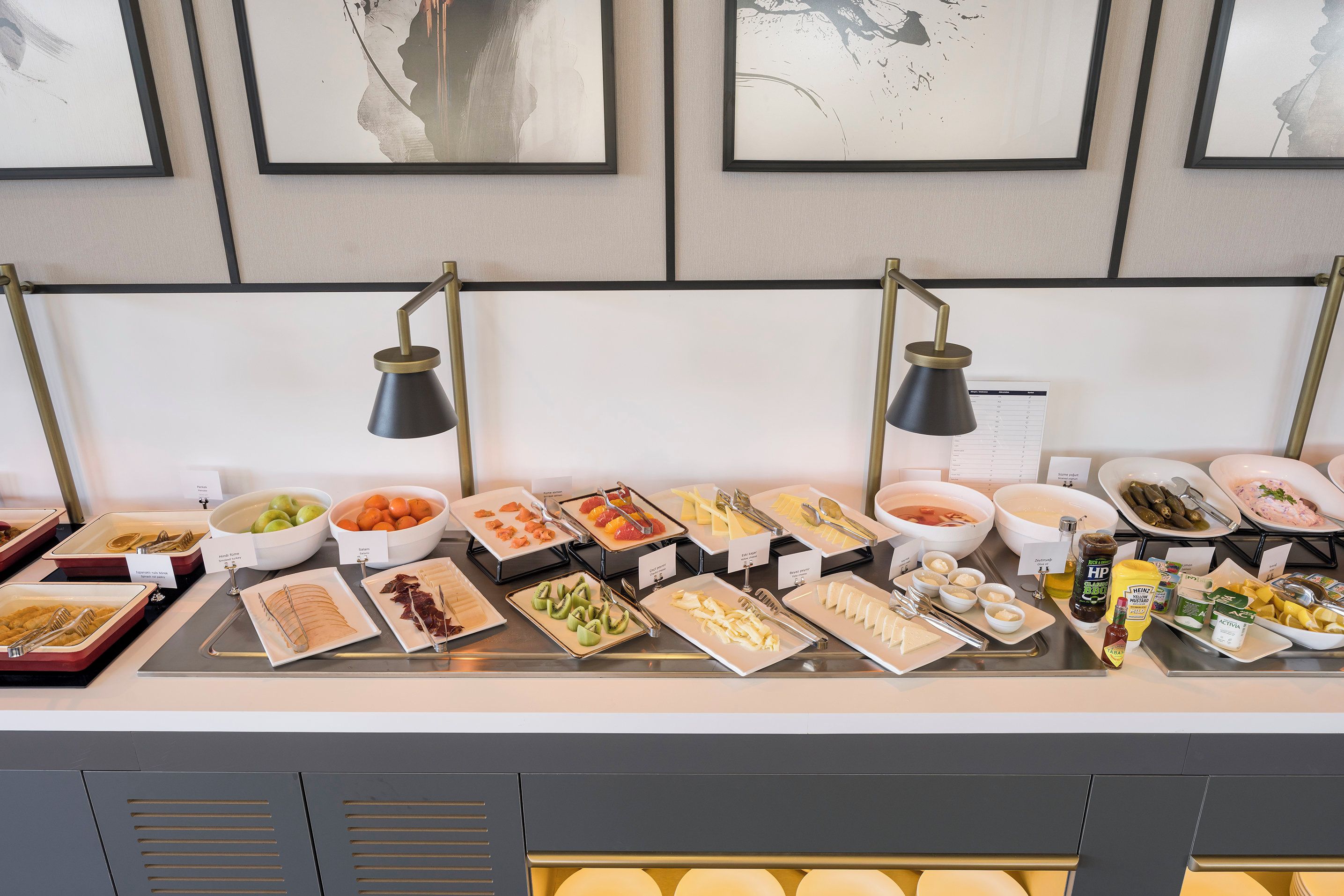 A buffet setup with various food items and condiments.