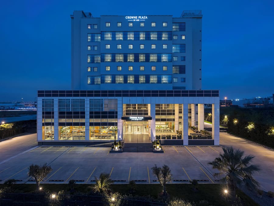 A hotel with a modern facade, large windows, and a well-lit entrance.