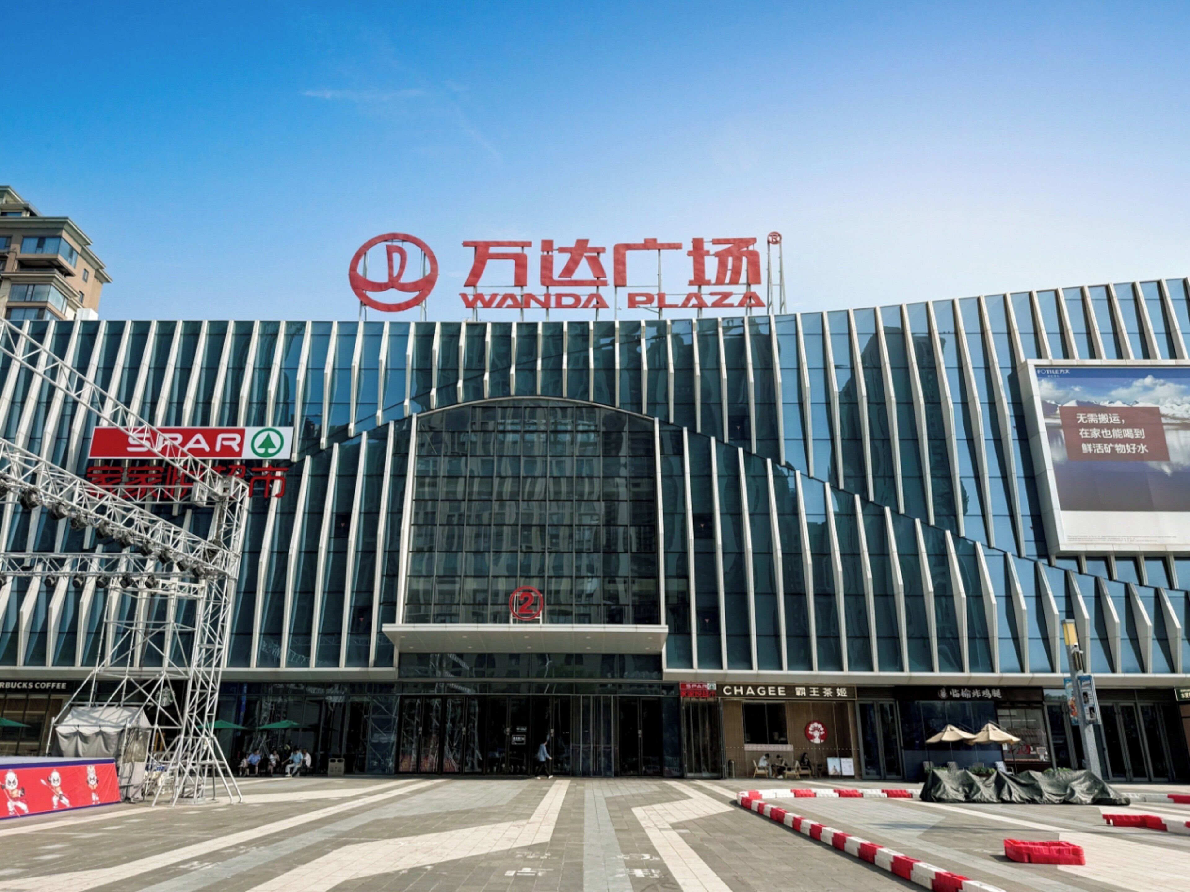 A modern building with a prominent sign reading 'Wanda Plaza.'