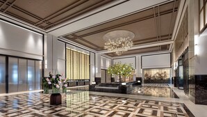 A spacious lobby with a reflective marble floor, a large chandelier, and a reception desk with a view of the interior. - Crowne Plaza Xiangyang Fuchun Lakeside by IHG (Xiangyang)