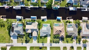 Une vue aérienne d’un quartier résidentiel avec des maisons, une rivière et un pont.