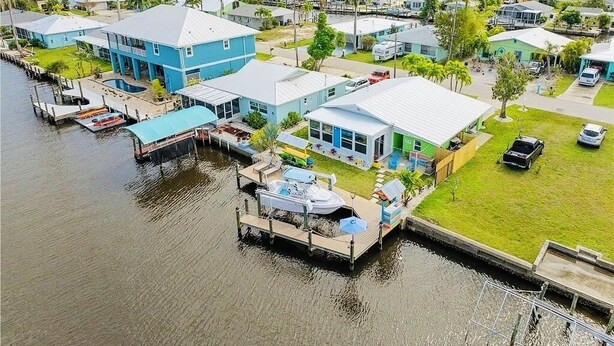 A waterfront property with multiple houses, docks, and a marina.