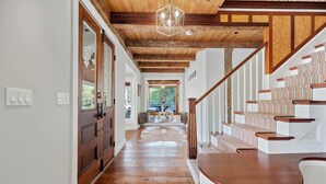A wooden staircase with patterned steps and a white banister. - Quintessential Vermont Charm in the Heart of Stowe Village (Stowe)