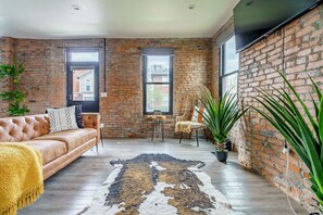 Jungle Jive | Living area | 55-inch Smart TV with digital channels, Netflix, Hulu - Jungle House Downtown Columbus – Modern Boutique Suites (Columbus)