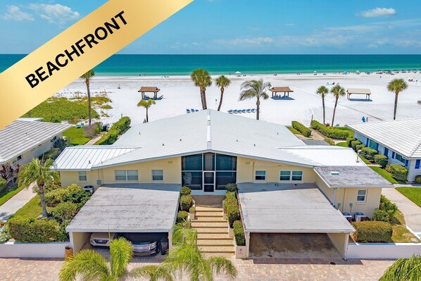 A beachfront hotel with a central building, multiple guest rooms, and a beach view. - Beachfront - Family-Friendly Beach Escape with Pool, Porch & Sun-Filled Fun – Aloha Kai #24 (Siesta Key)