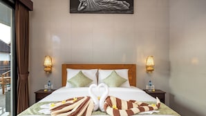 A hotel room with a neatly made bed, two nightstands with lamps, a painting on the wall, and a window with curtains. - The Tis Guesthouse and Hostel (Canggu)