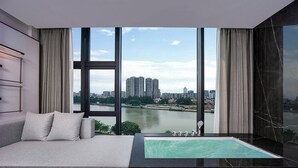 A modern bedroom with a large window, a sofa, and a small pool. - Guangzhou Elegant International Hotel Panyu Square Metro Station Branch - Free Shuttle Bus to Canton Fair Complex During Canton Fair Period & Free Deliver Service to Guangzhou Baiyun International Airport (Guangzhou)