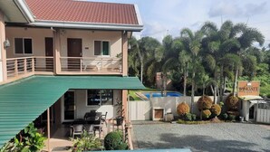 A two-story building with a covered patio, a swimming pool, and a sign for 'Wikigate'. - Hanan Hotel Tagaytay (Tagaytay)