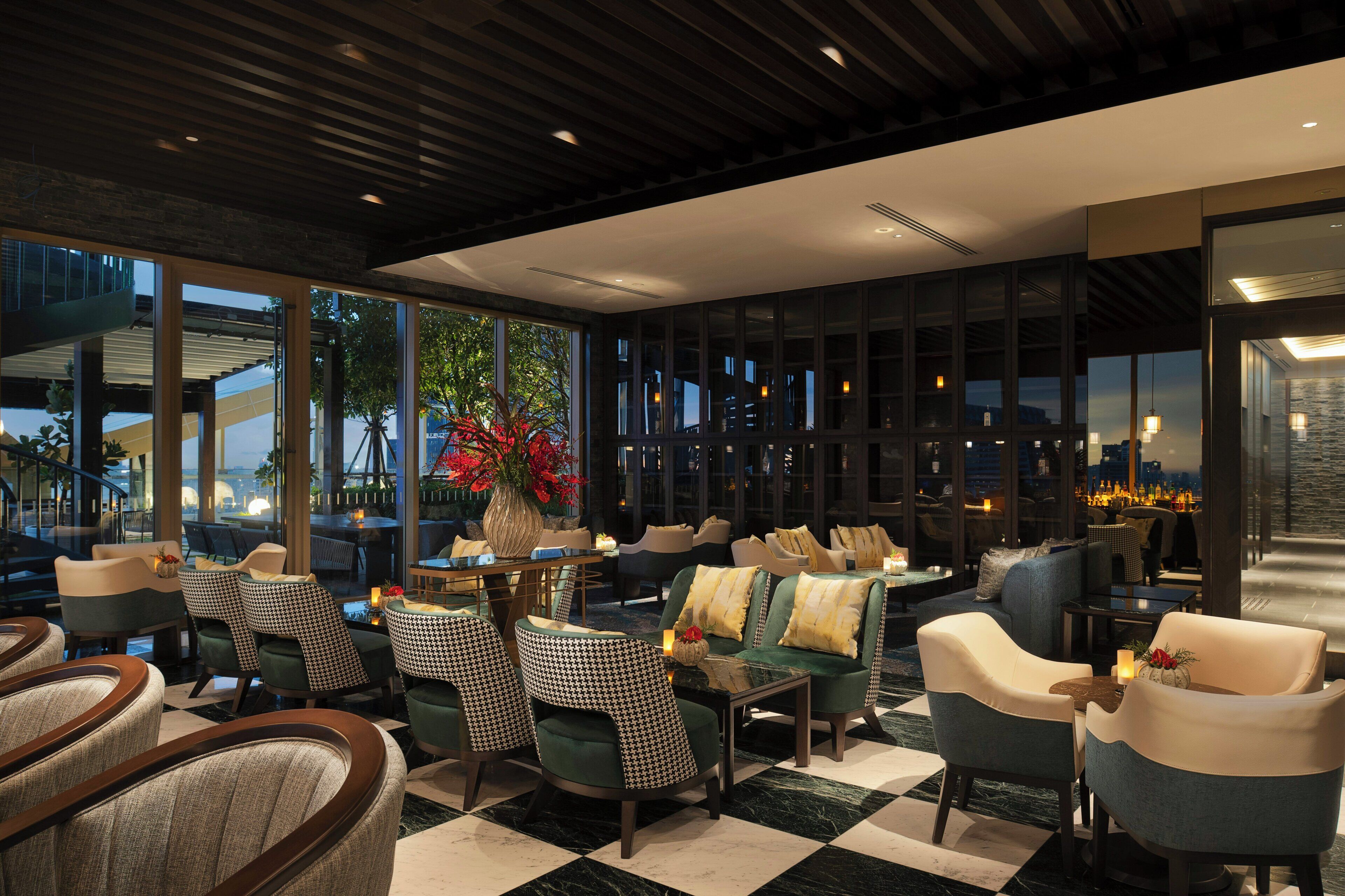 A modern lounge area with seating, a coffee table, and a decorative vase.