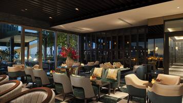 A modern lounge area with seating, a coffee table, and a decorative vase.