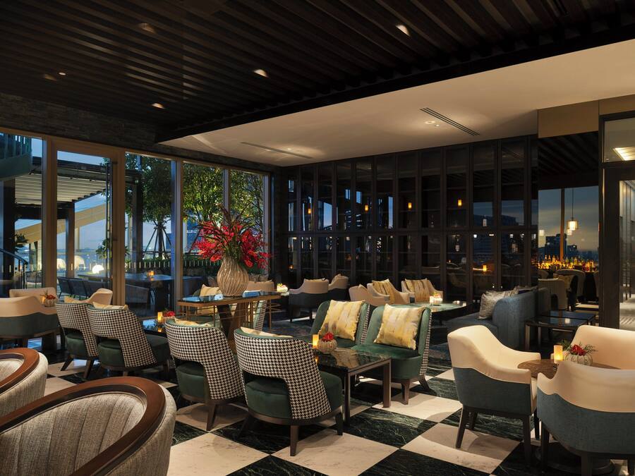 A modern lounge area with seating, a coffee table, and a decorative vase.