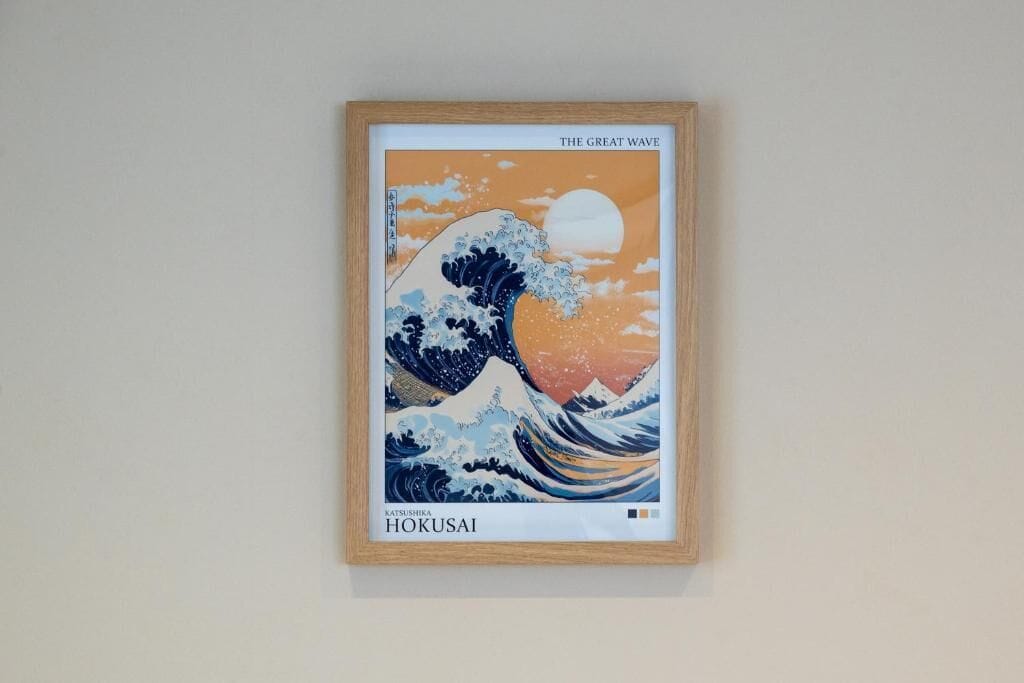 Une œuvre d’art encadrée représentant « La Grande Vague » de Katsushika Hokusai.