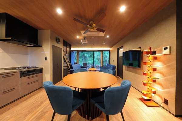 The sophisticated wooden dining table and blue accent chairs make mealtimes even more special.