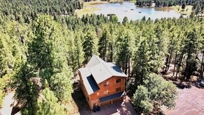 A lodge surrounded by dense forest and a lake. - Spacious Family Mountain Cabin ~Fireplace ~2 Decks ~Near Lake (Munds Park)
