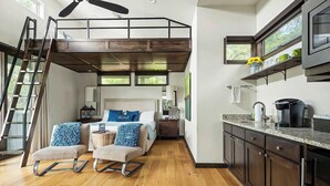 A loft-style bedroom with a bunk bed, a ladder, a small bedside table, and a nightstand. - Charming Lake Getaway with Loft / Pickleball / BBQ (Lake Travis)