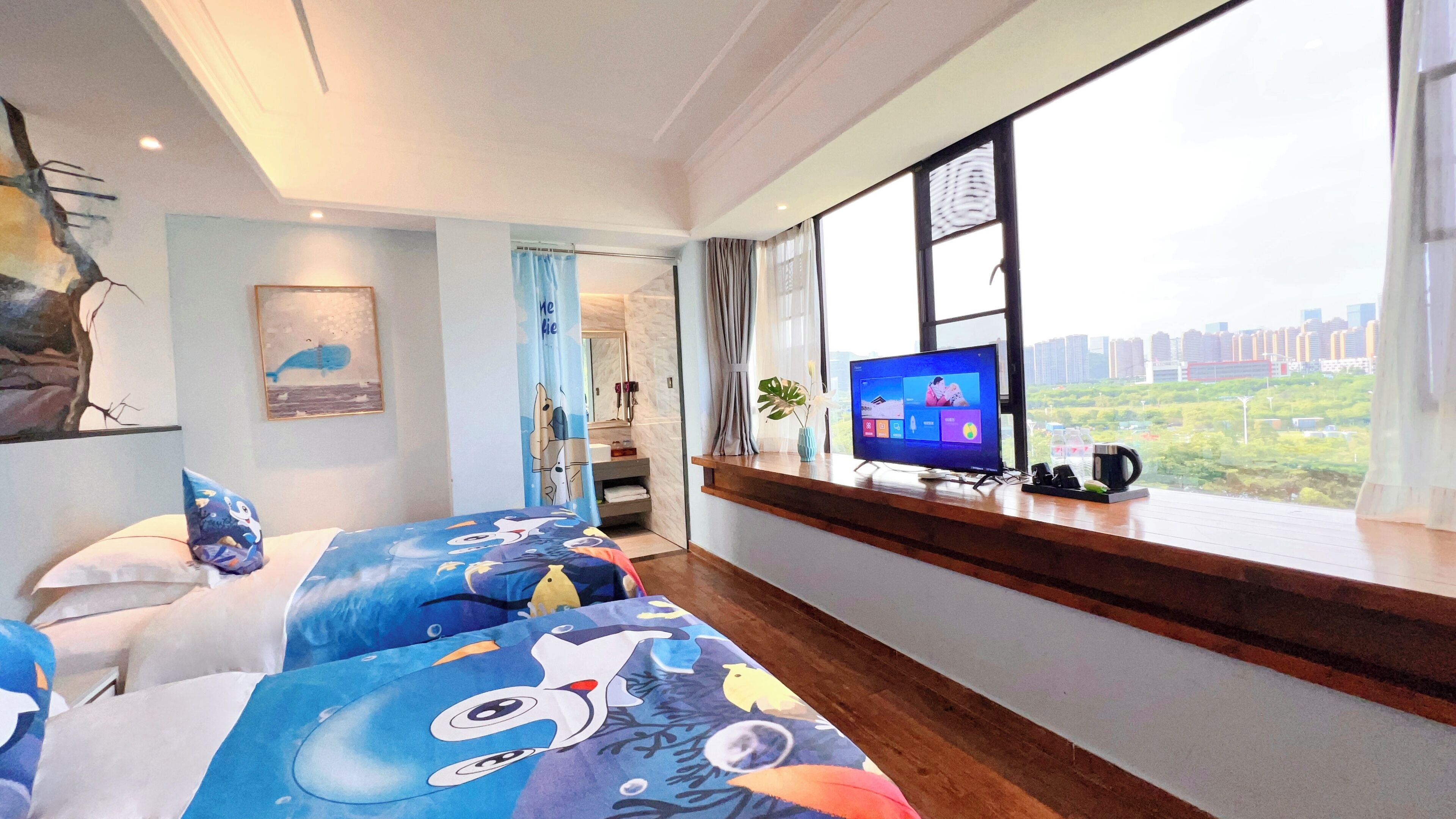 A hotel room with a large window, a bed with a colorful bedspread, a television on a wooden console, and a view of a cityscape.