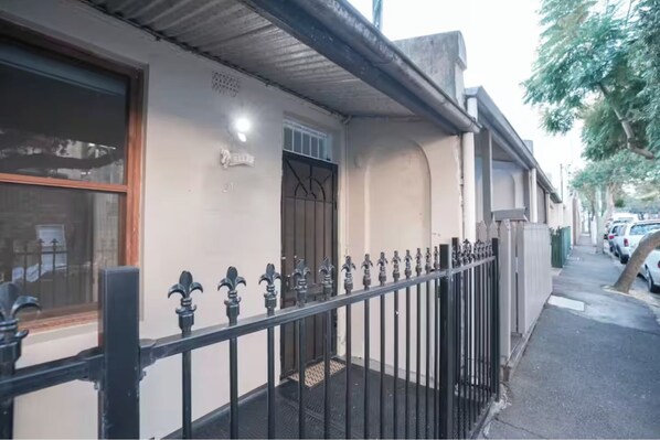 A building with a metal fence, a door, and a window. - 4BR 4mins to light rail 9mins FishMarket (Pyrmont)