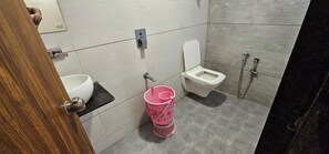 Deluxe Room, City View | Bathroom | Shower, slippers - Hotel Aaryodaya (Ahmedabad)