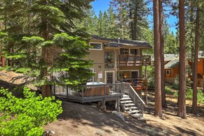 A two-story lodge with a deck and stairs leading to the entrance. - Family Retreat | Master Suites-Hot Tub | Sleeps10 (Stateline)