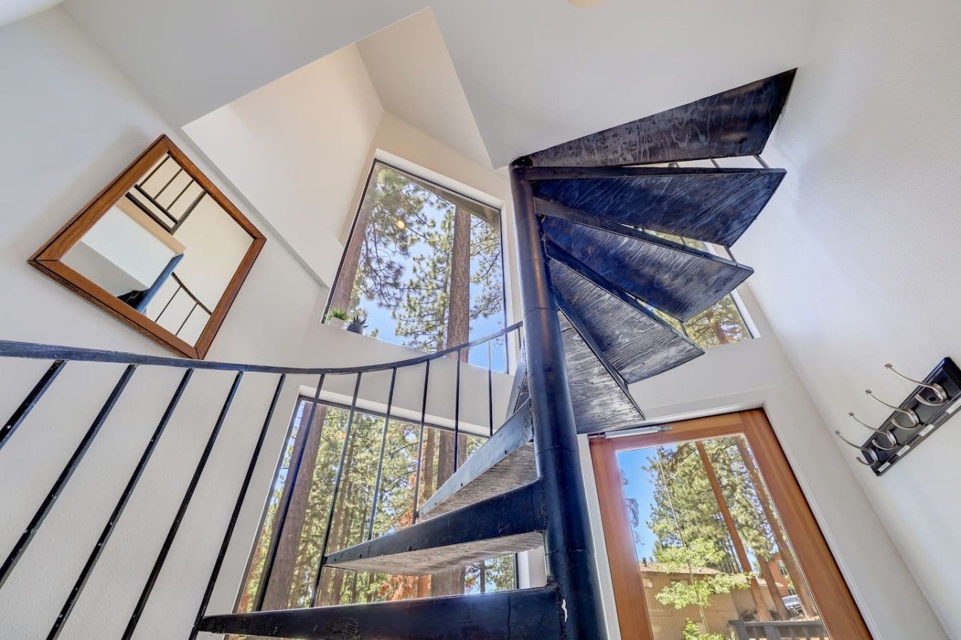 A spiral staircase with a modern design, leading to an upper floor.