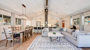 A modern interior with a dining area, kitchen, and living space.