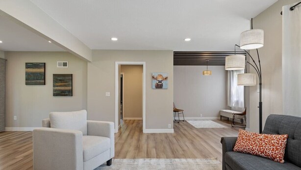 A modern living room with a sofa, armchair, and a rug. - Sleeps 10, Available Garage! (Sturgis)