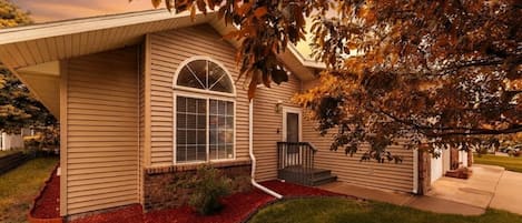 A single-story house with a front porch, a covered entryway, and a visible garage door.