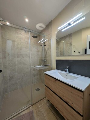 Shower, hair dryer, towels, toilet paper