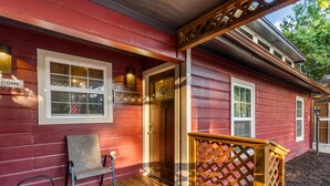 A red wooden building with a porch, a bench, and a sign that reads "The Longhorn." - Stockyards Longhorn House, 1/8 mi to Stockyards-Sleeps up to 11-add 10 next door (Fort Worth)