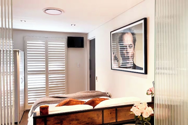 Immaculate room with ergonomic massage bed, heated floors and storage.